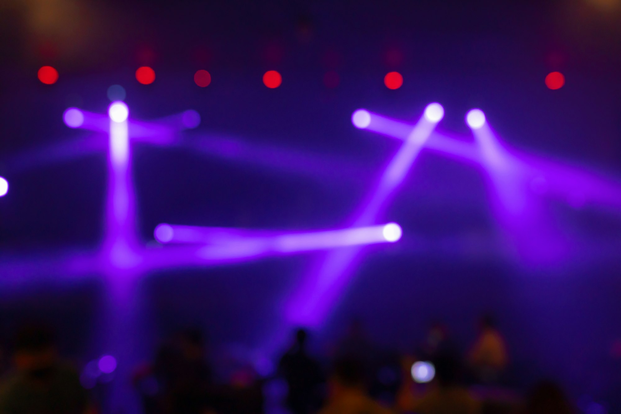 Abstract blurred photo of spotlight on the stage in conference hall or nightclub,