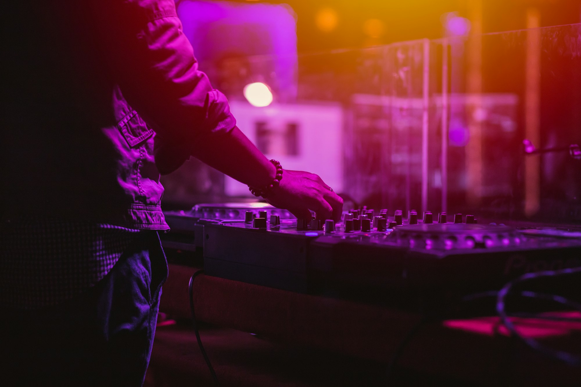 professional stage sound mixer closeup at sound engineer hand using audio mix slider working during